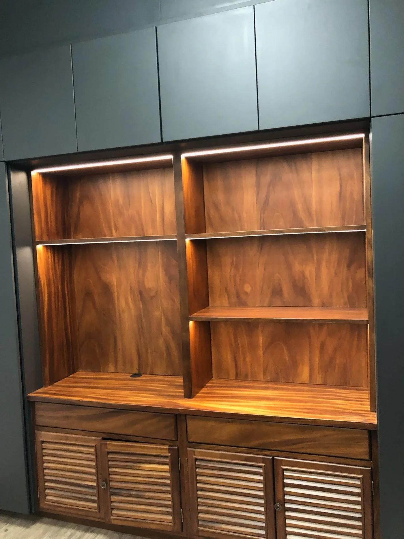 Librero de madera con perfiles LED lineales en los entrepaños